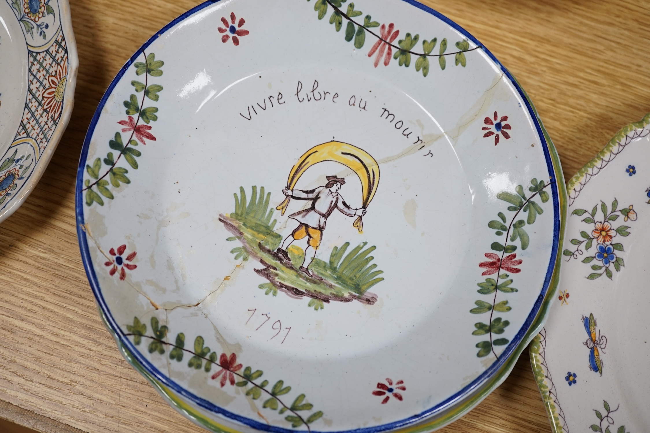 A collection of twenty 18th/19th century French faience polychrome and blue and white Revolution commemorative plates and three others, largest 27cm diameter (23). Condition - condition varies poor to good